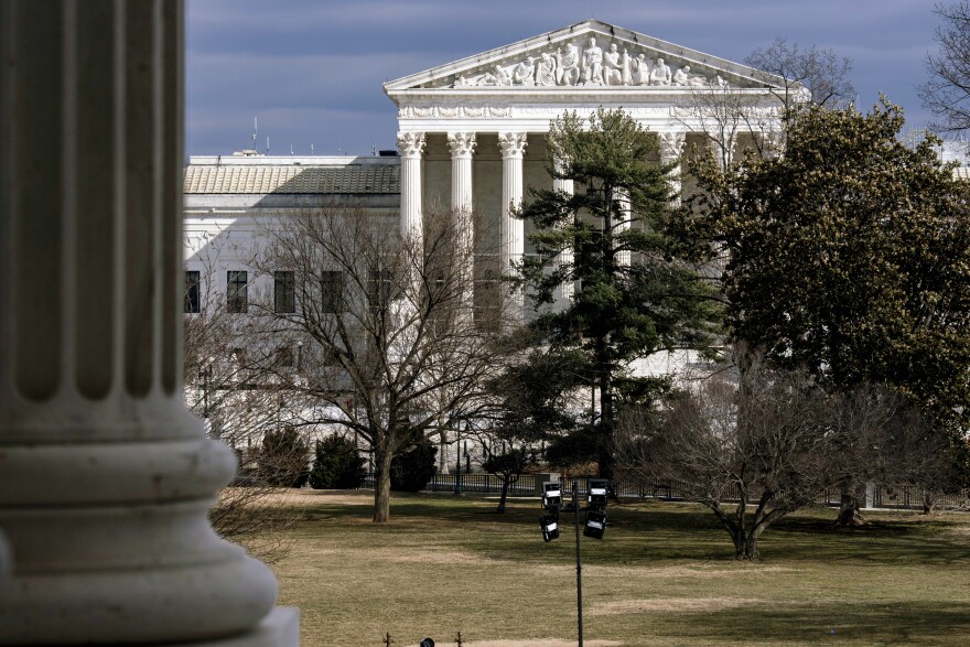 FILE - The Supreme Court is seen in the distance, framed through columns of the U.S. Senate at the Capitol in Washington, Feb. 20, 2025.