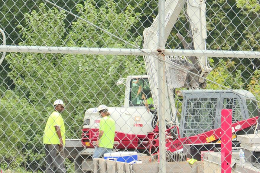 A contractor hired by Citizens Energy is cleaning up oily rocks and material from the area of the river where the oil was discharged this week.