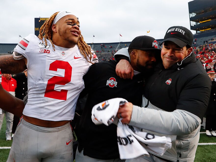 Ohio State defensive end Chase Young (2), linebackers coach Al Washington and head coach Ryan Day celebrate after a 56-27 win against Michigan after an NCAA college football game in Ann Arbor, Mich., Saturday, Nov. 30, 2019. 