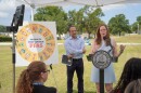 Sarah Burns, is the water planning manager for the City of Tampa, she wears a light grey dress and has red hair. 