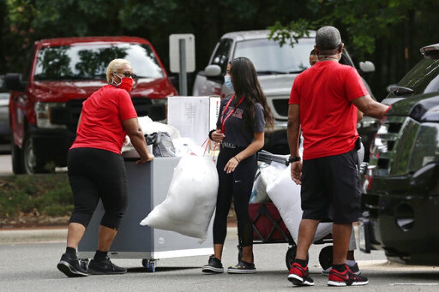 File photo of college students, with the assistance of their families, moving in for the fall semester at N.C. State University in Raleigh, N.C., Friday, July 31, 2020.