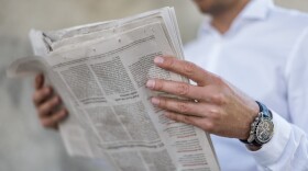 A man reads a newspaper. (Getty Images)
