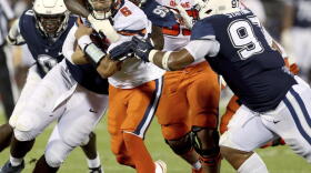 Syracuse quarterback Garrett Shrader (6) is tackled during an NCAA college football game against Connecticut in East Hartford, Conn., Saturday, Sept. 10, 2022.