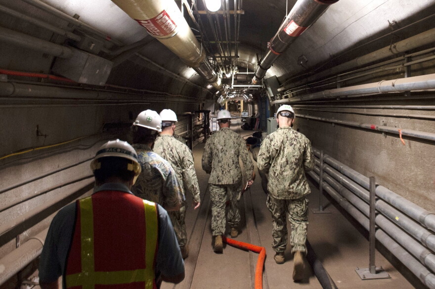 Rear Adm. John Korka, Commander, Naval Facilities Engineering Systems Command (NAVFAC), and Chief of Civil Engineers, leads Navy and civilian water quality recovery experts through the tunnels of the Red Hill Bulk Fuel Storage Facility, near Pearl Harbor, Hawaii, on Dec. 23, 2021. 