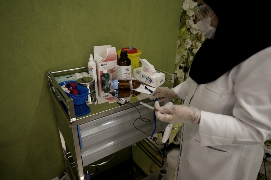 A nurse prepares chemotherapy medications for patients at the Roshana Cancer Center. An oncologist there says the limitation goes beyond goods and supplies.