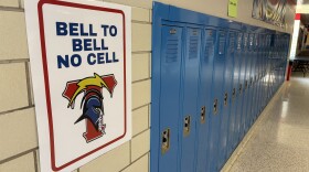 A sign at Wichita South High School reads "Bell to Bell No Cell," reminding students not to use their phones during the school day. A new state law bans student cell phone use in K-12 schools.