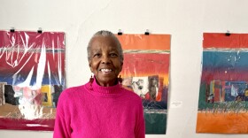 Milwaukee artist, Evelyn Patricia Terry, standing in her home in front of her art