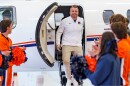 man gets off private plane greeted by cheerleaders in orange and blue 