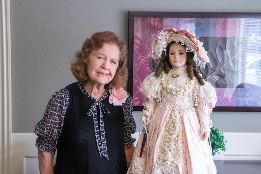 Golden Age Nursing Home resident Brenda Gilliland poses next to her porcelain doll, Lady Mary.