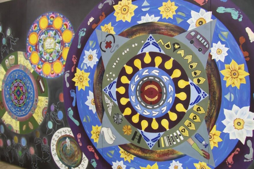 A mural completed by evacueees and a local artist is expected to travel throughout the state.