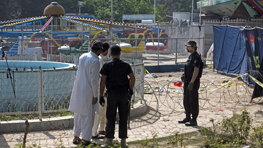 Pakistani police on Monday cordon off the scene of the suicide bombing at a park in Lahore.