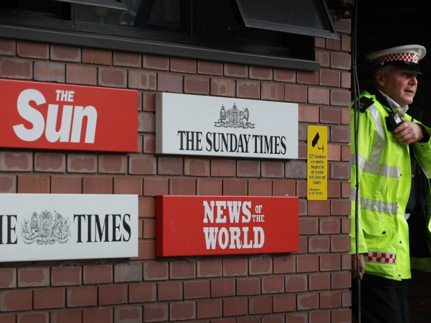 A policeman walks through the security gates at News International's wrapping plant on July 7 in London.