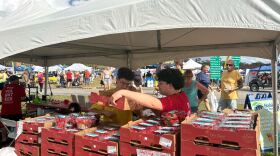 Volunteers sell cartons of strawberries during the 12th annual Habitat for Humanity Ocala Strawberry Festival. Organizers said proceeds from the event help fund home construction for local families in need.