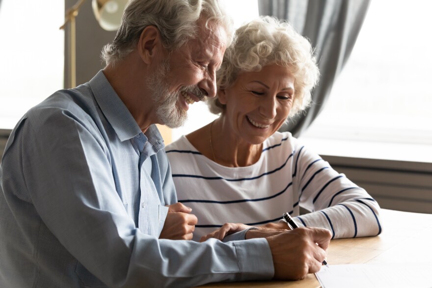 Satisfied senior couple at lawyer office signing prenuptial agreement marriage articles, 70s spouses make decision buying medical life health insurance, concept of testament last will and inheritance