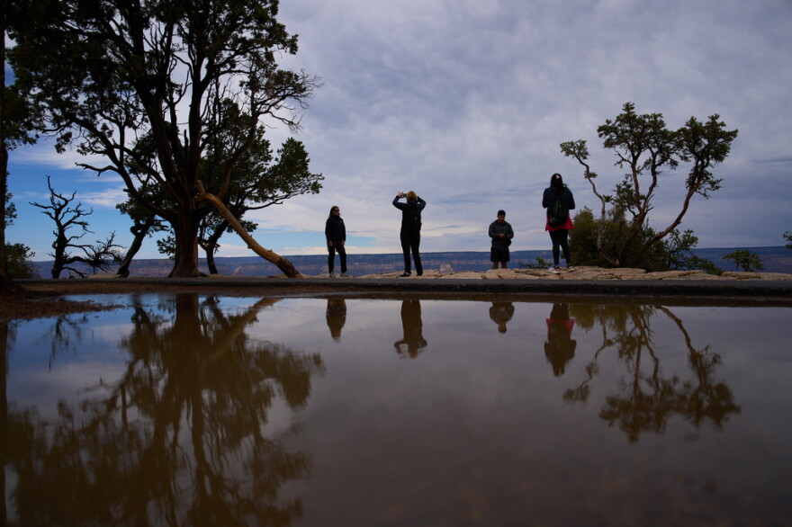 People stand at the rim of the Grand Canyon, Monday, Aug. 31, 2026, in Grand Canyon National Park, Ariz.