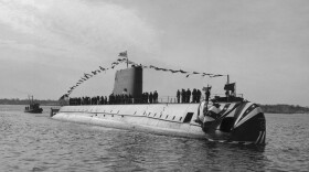 (Original Caption) The USS Nautilus is launched at ceremonies here at General Dynamics Corporation's Electric Boat Division shipyard, in Groton, Connecticut. Christened by Mrs. Dwight D. Eisenhower with nearly 30,000 Navy and civilian guests looking on, Nautilus was the first true submarine and could "travel around the world without surfacing or refueling at speeds in excess of 20 knots." Nautilus keel was laid by then President Harry S. Truman, June 14, 1952.
