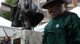 Sibling sculptors Judith, left, and David Rubin flank their 6-foot bronze sculpture of William Seward in front of the Alaska Capitol. (Photo by Jacob Resneck/KTOO)