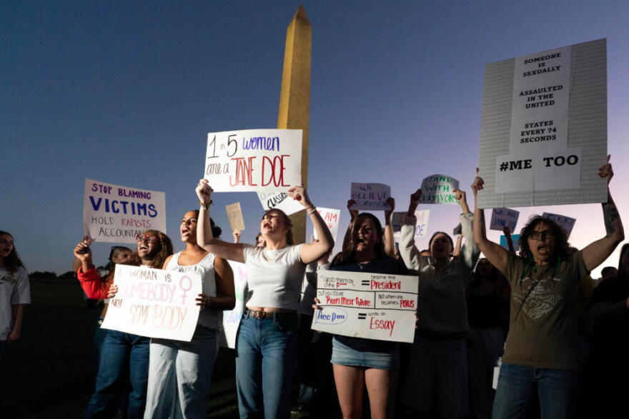 Demonstrators rally during a "Stop Sexual Violence" protest at the Washington Monument, Thursday, Oct. 8, 2026, in Washington. (Jose Luis Magana/AP)