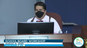 man wearing a black face mask during a meeting