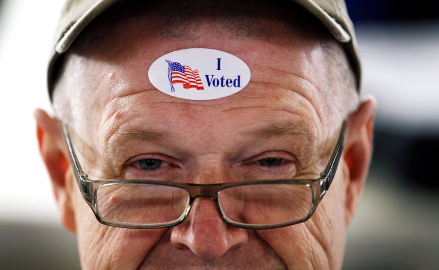 John Vandermark wears an "I Voted" sticker after voting in the Michigan primary at Royal Oak Farmers Market, in Royal Oak.