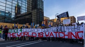 Demonstrators in Minneapolis march during a protest after the opening arguments in the murder trial of former police officer Derek Chauvin, who is on trial for the murder of George Floyd. 