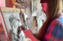 Artist Michael Sinclair works on a portrait as part of his DiedFamous project. (Photo: Rebecca Cisneros)