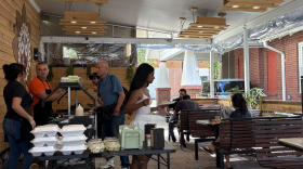 People line up and eat at the Krishna House dining area on Wednesday, March 11, 2026.