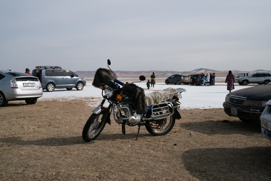 Cars and motorcycles draped with fur line the banks of the Tamir as players gather for the season's final ice shooting competition in early March.