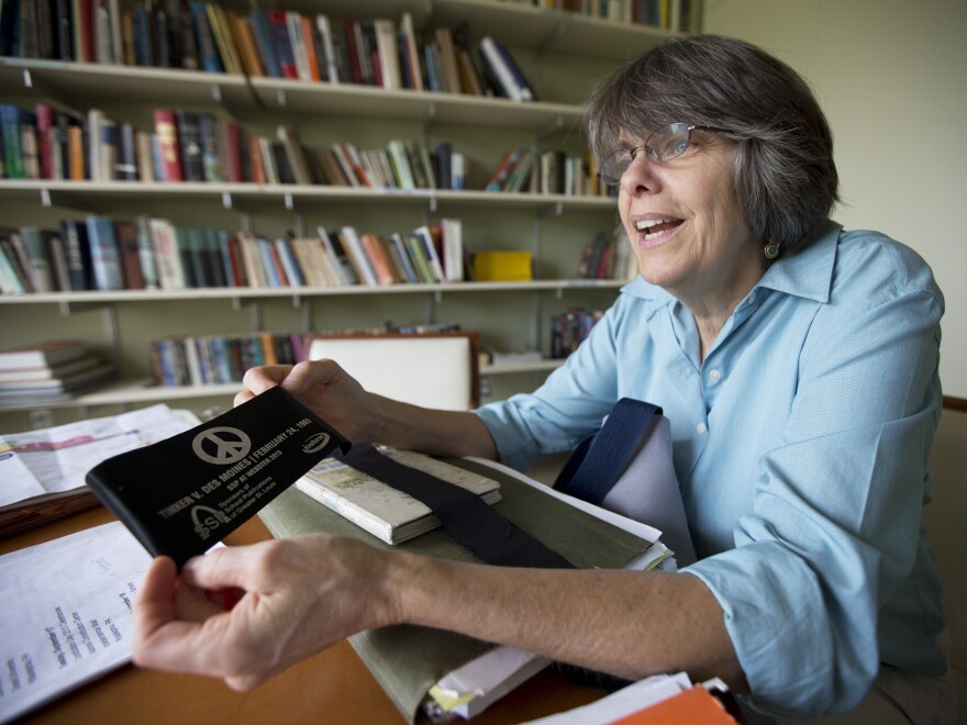 Tinker shows one of her collection of armbands during a 2013 interview with The Associated Press.