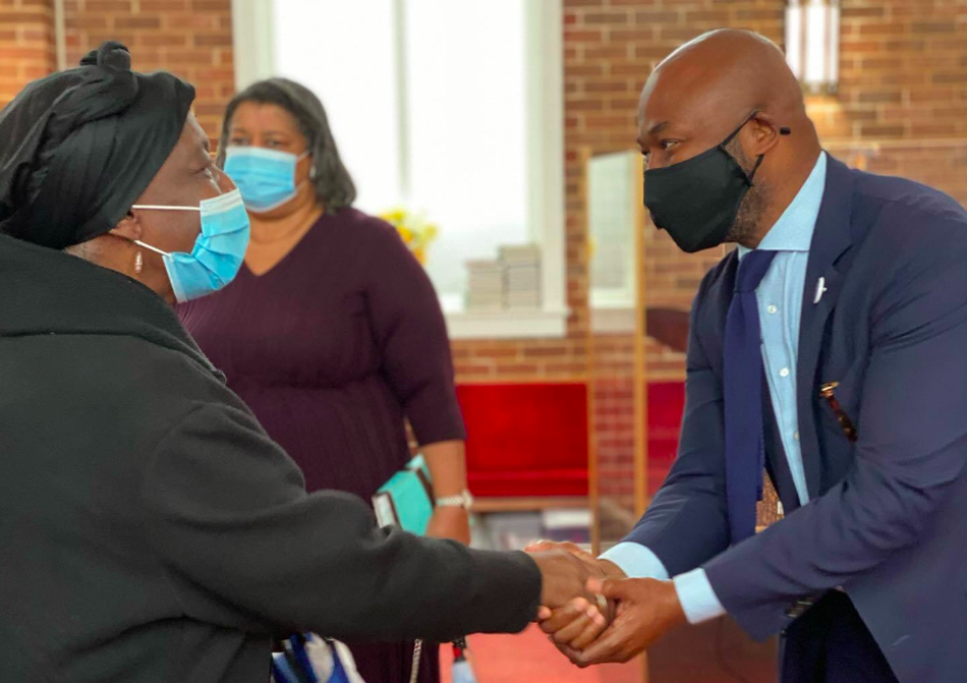 Jason Williams greets a voter at New Zion Baptist Church. Nov. 29, 2020.