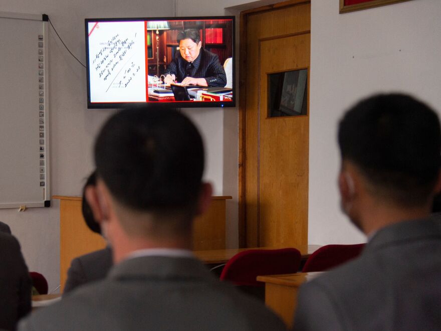 In this photo taken in Pyongyang, North Korea, on March 25, 2022, students of the Pyongyang Jang Chol Gu University of Commerce watch footage of North Korean leader Kim Jong-Un along with news of the previous day's launch of the Hwasong-17 missile — Pyongyang's first ICBM test since 2017.