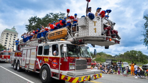 UF Cheerleaders ride on a Gainesville Fire Rescue truck during the University of Florida Homecoming parade Oct. 9, 2026, in Gainesville, Fla. (Andy Acosta/WUFT News)
