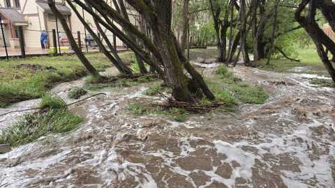 Poison Creek in Old Town Park City overflows during a July 2026 rainstorm.