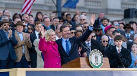 Gov. Andy Beshear and his wife Britainy wave to the crowd at the public swearing-in ceremony in Frankfort, Kentucky on Dec. 12, 2023.