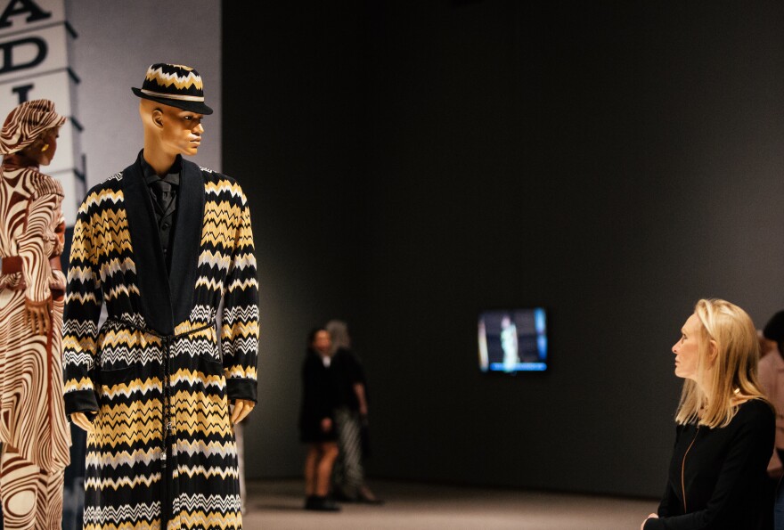 A woman looks a mannequins on display at the North Carolina Mueum of Art during the opening night of the exhibit, Inspiring Beauty: 50 Years of Ebony Fashion, in Raleigh, N.C. on Saturday, Oct. 28, 2017.