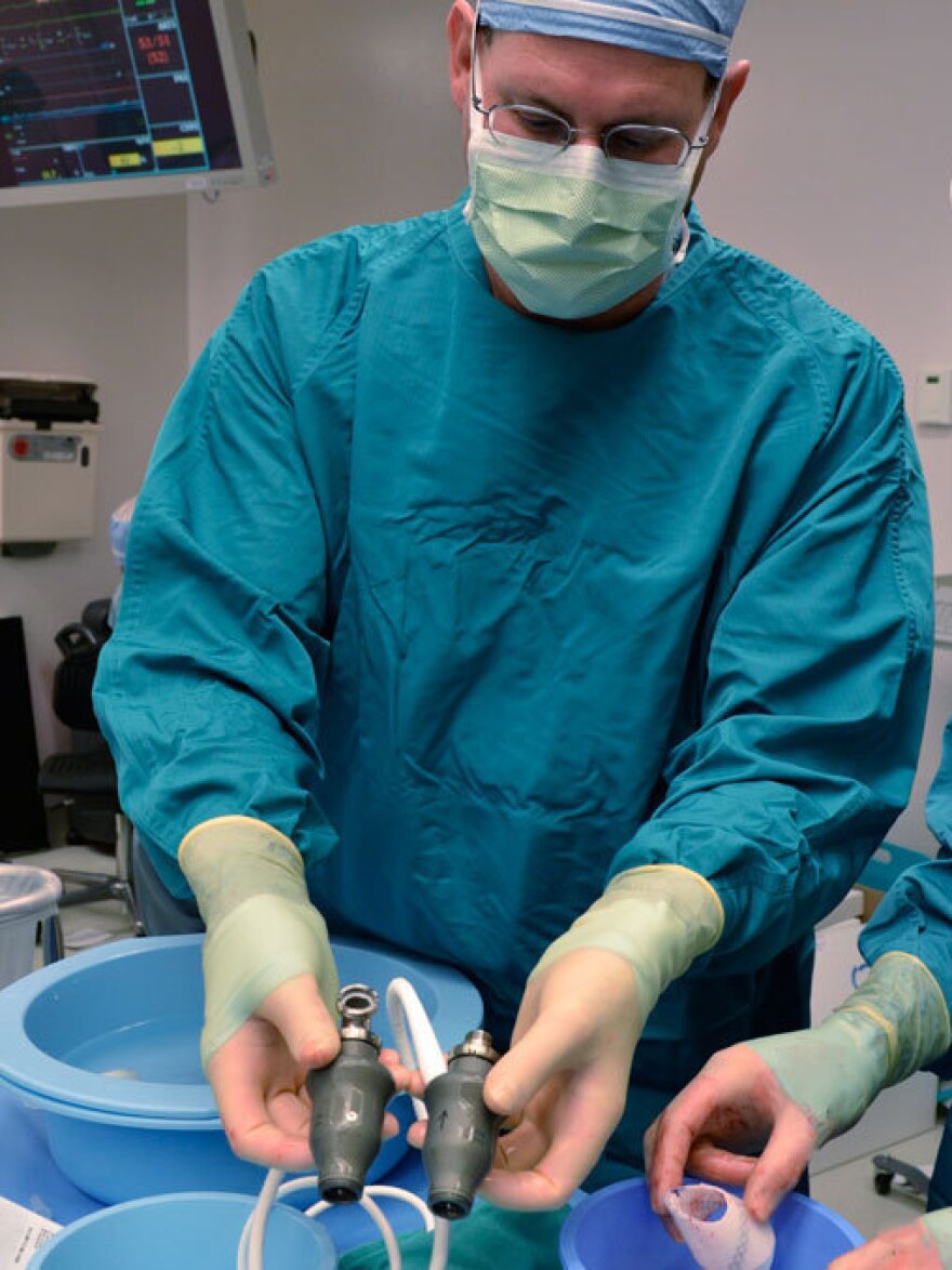 Steven Parnis, assistant director of technology development at the Texas Heart Institute, prepares the pair of ventricular assist devices for surgery. These devices use spinning rotors to circulate blood, instead of rhythmic contractions.