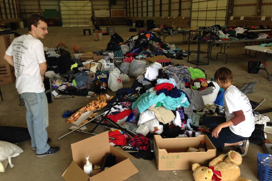 DePauw University Sustainability Director Anthony Baratta and Amber Hecko, assistant director of DePauw's Environmental Fellows Program, sort through truckloads of donated goods.