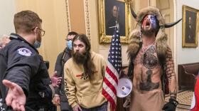 In this Jan. 6, 2021, file photo, is Jacob Chansley, right with fur hat, during the Capitol riot in Washington. Chansley was sentenced to 41 months in prison on Nov. 17, 2021.