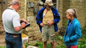 FEMA contractor Bill Bagger (l) assesses damage to the home of David and Gail Gosnell