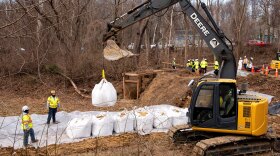Workers build a cofferdam to stop the flow of raw sewage into the Potomac River after a massive sewage pipe rupture in Glen Echo, Md., Friday, Jan. 23, 2026. (AP Photo/Cliff Owen)