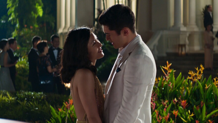 Rachel (Constance Wu) and Nick (Henry Golding) share a moment in the Singapore moonlight in <em>Crazy Rich Asians</em>.