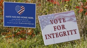signs on a lawn in medina ohio that read "hate has no home here" and "vote for integrity"