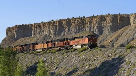 A train transports freight on a common carrier line near Price, Utah, July 13, 2023. The Supreme Court has agreed to consider reviving a critical approval for a railroad project that would carry crude oil and boost fossil fuel production in rural eastern Utah. The justices said Monday they will review an appeals court ruling that overturned the approval issued by the Surface Transportation Board for the Uinta Basin Railway, an 88-mile railroad line. (AP Photo/Rick Bowmer, File)
