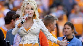 Dolly Parton performs during the first half of an NCAA college football game between Tennessee and Georgia Nov. 18, 2023, in Knoxville, Tennessee. (Wade Payne/AP)