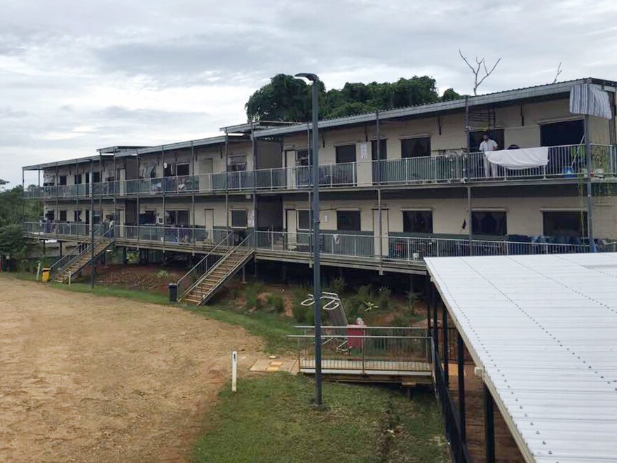 In this July 17 photo provided by Aziz Abdul, a man standing on a balcony at the East Lorengau Refugee Transit Center on Manus Island, Papua New Guinea. The question of what will become of the hundreds of asylum-seekers banished by Australia to sweltering immigration camps in the poor Pacific island nations of Papua New Guinea and Nauru has become more pressing.
