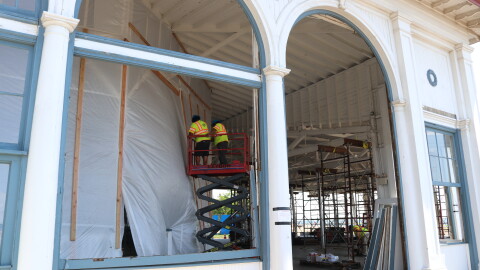 Construction crews work on the structure, which was stabilized in case of another storm.