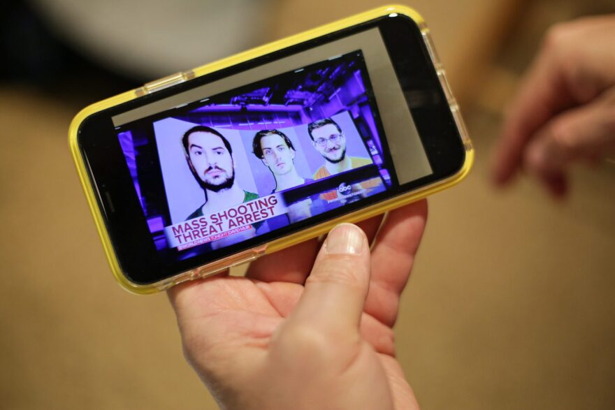 Lee Ann Potter shows a news video featuring Brandon Wagshol (left), which she recorded on her cell phone. 