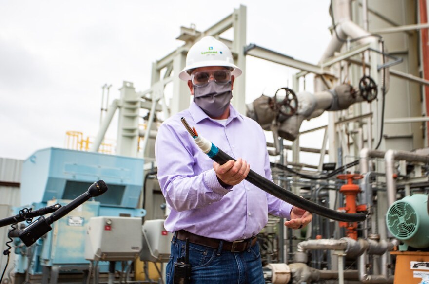 Plant Manager Curt Terry shows heat tracing wires used to warm pipes.