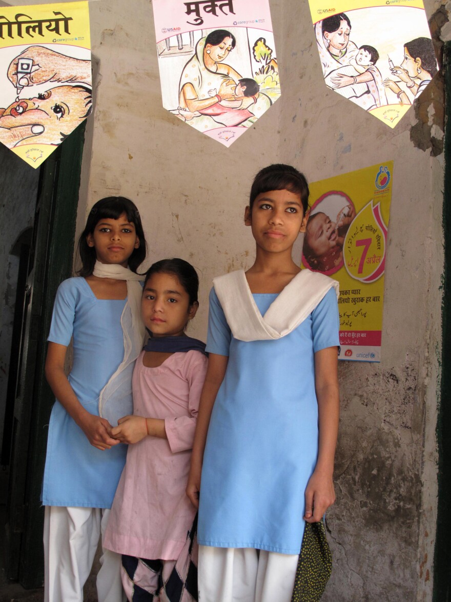 The whole community comes out during the polio vaccination campaigns. These school girls stopped by an immunization booth just to watch the action.