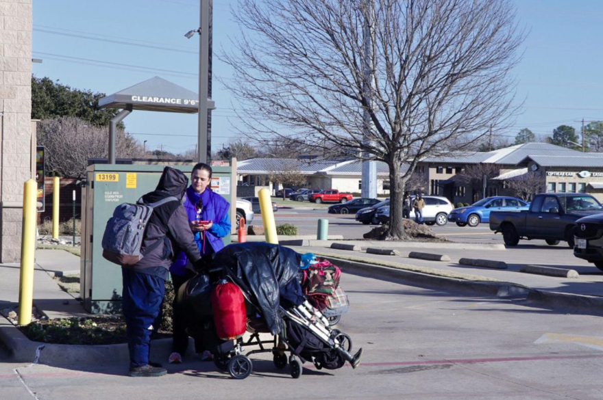 Volunteer Shelby Redondo talks with a man experiencing homelessness in a parking lot on University Drive during the 2025 point-in-time count.